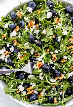 a salad with blueberries, feta cheese and walnuts