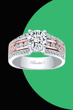 a diamond engagement ring with two bands on the side and a green circle in the background