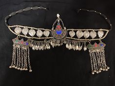 * This traditional craft is headpiece, also known as mathapatti in many local regions of Himalaya. The handcrafted article is showcasing the hundreds of years old customary practices and style of ornaments. The dangling tassels and multicolor stones are flaunting all the traditional vibes. You can pair this elegant piece of craft with traditional or customary attire, and it would get along your chosen fashion statement. The details with every product might vary a bit because all these products a Afghan Culture, Boho Cuff Bracelet, Hand Cuff Bracelet, Matha Patti, Boho Cuff, Afghan Jewelry, Headpiece Jewelry, Head Piece, The Hundreds