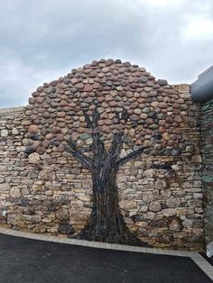 a stone wall with a tree painted on it