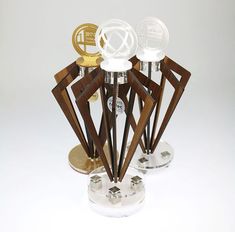 an assortment of glass and wood items on display in a holder with two metal bases