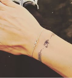 a woman's arm with a small tattoo on the wrist and an arrow in the middle