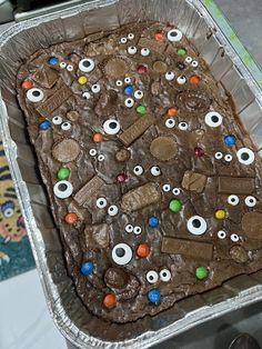 a chocolate cake with googly eyes and candy eyeballs on it's side