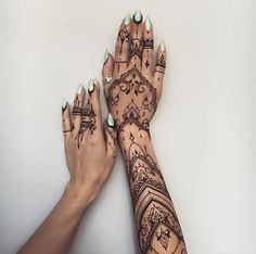 two hands with hendi designs on them