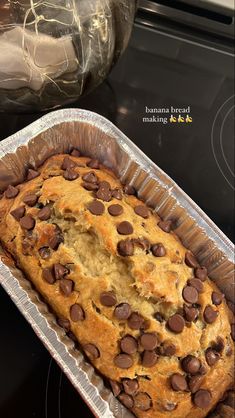 a loaf of banana bread with chocolate chips in it sitting on top of a stove