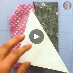 someone is making a paper airplane out of fabric