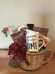 a coffee mug sitting in a basket filled with goodies