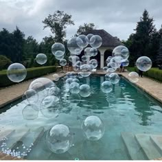 soap bubbles floating in the air over a pool