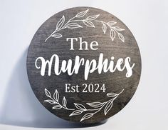 a wooden sign that says the murpies est 2024 on it with leaves