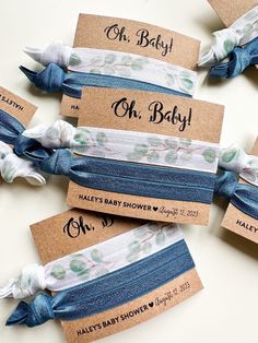 four baby shower headbands with blue and white flowers are on top of each other