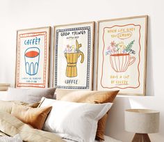 three framed art prints on the wall above a bed with pillows and throw pillows in front of them