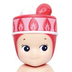 a small doll with a pink hat on top of it's head and eyes