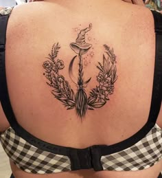 a woman's back with a tattoo on her left side and an arrow in the middle