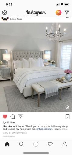 a white bedroom with chandelier, bed and ottoman in the middle is featured on instagram