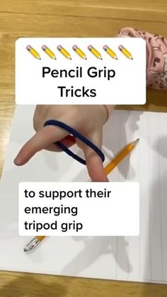 a person's hand is pointing at the pencils they have on their fingers