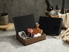 an open box with wine bottles and other items