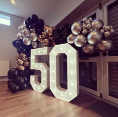 the number 50 is displayed in front of balloons