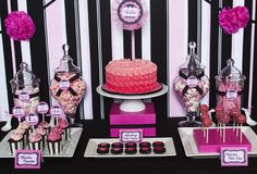 pink and black dessert table with striped wall