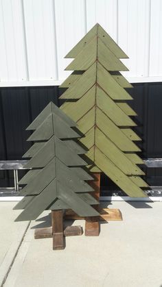 two wooden christmas trees sitting next to each other