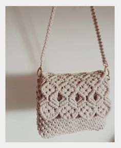 a crocheted purse hanging from a hook