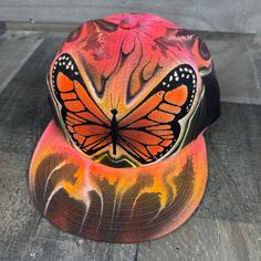 This is an airbrushed snapback hat featuring a Butterfly design.  This hat is adjustable and will fit almost anyone.  These hats are waterproof and can withstand a good soaking but they should not be washed in a washing machine or dish washer.  Thank you, Brad.  Shipping is free for this item anywhere in the US. Airbrush Hat Ideas, Multicolor Snapback Hat With Flat Bill, Multicolor Adjustable Snapback Hat With Flat Bill, Adjustable Multicolor Snapback Hat With Flat Bill, Hip Hop Adjustable Fitted Hat For Outdoor, Multicolor Adjustable Snapback Fitted Hat, Adjustable Multicolor Snapback Fitted Hat, Artistic Snapback Hat One Size Fits Most, Artistic Snapback Hat, One Size Fits Most