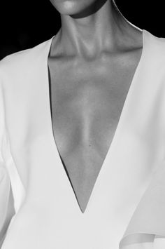 a close up shot of a woman's face and shoulders, wearing a white dress