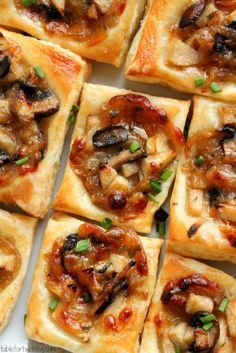 small square pizzas with meat and mushrooms on them