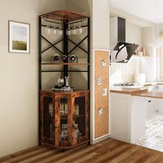 a kitchen with an open shelving unit in the center and wood floors on the other side