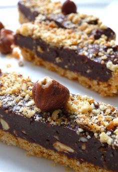 two pieces of chocolate and nuts bar on a white plate