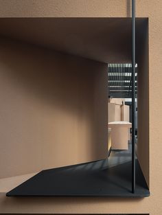 an empty room with boxes in the corner and a metal pole sticking out of the wall