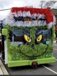 a green bus decorated like a grin face