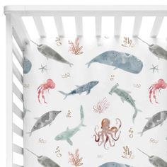 an ocean themed crib bedding set with marine animals and octopuses on it