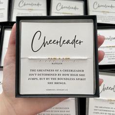 a person holding up a card that says cheerleader in front of other cards with writing on them