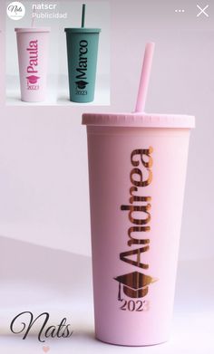 a pink cup with a straw in it and two other cups next to each other