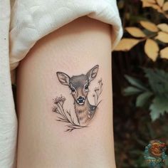 a small deer tattoo on the right thigh