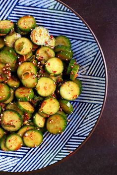 a blue and white plate topped with sliced up brussel sprouts covered in sesame seeds