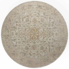 a round rug with an intricate design on the top and bottom, in grey tones