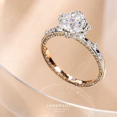 a diamond engagement ring sitting on top of a table