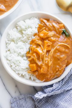 two bowls filled with rice and curry on top of a table