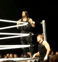 two men standing on top of a wrestling ring