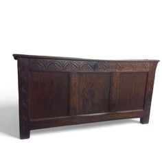 an old wooden headboard with carvings on the top and bottom panel, against a white background