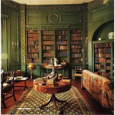 a living room filled with furniture and bookshelves