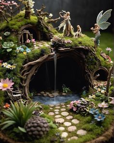 a fairy garden with lots of plants and flowers