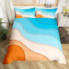 a bed with blue, orange and white waves on it