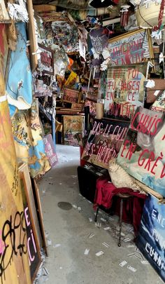 there are many signs on the wall in this room that is covered with graffiti and other items