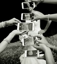 a group of people holding up their cell phones