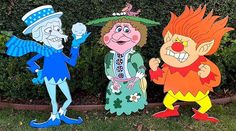 three cartoon characters standing next to each other in front of a bush and shrubbery