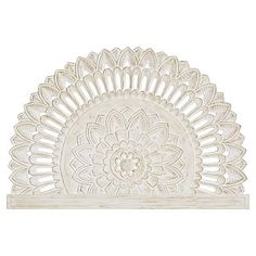 an intricately designed white wall shelf