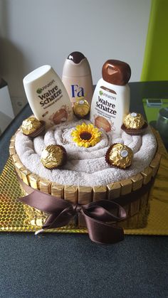 a cake decorated with sunflowers, chocolates and other items on a table