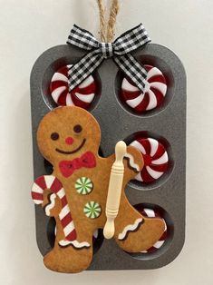 an ornament made to look like a gingerbread man with candy canes